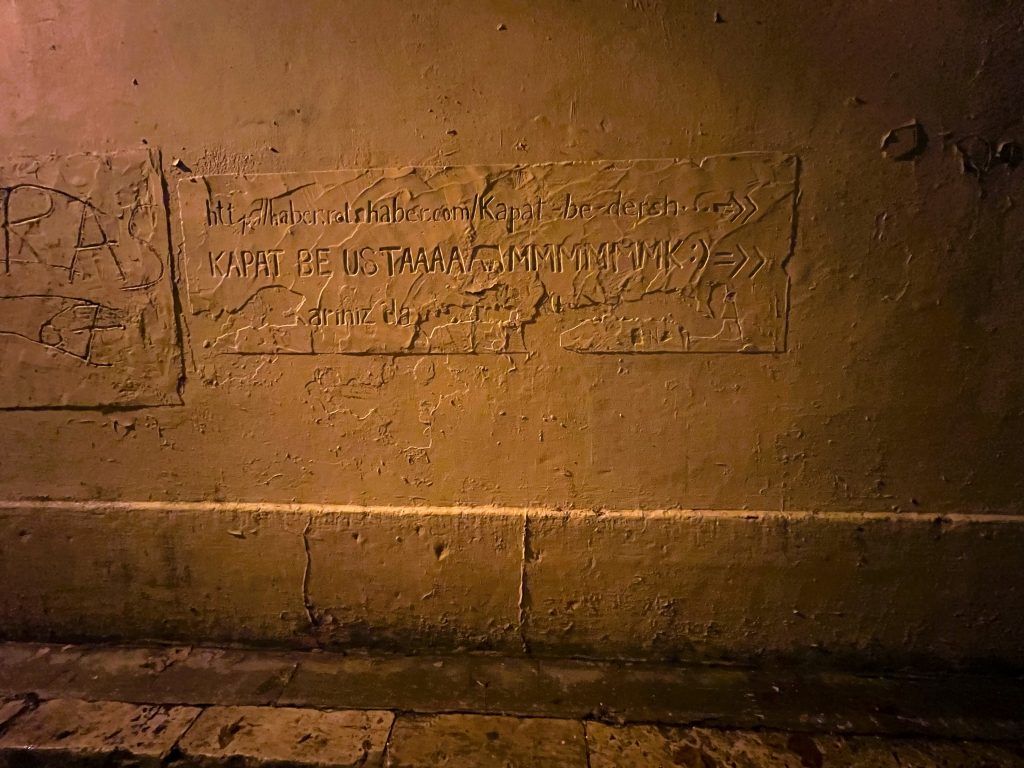 a photo of a wall with Turkish writing on it 