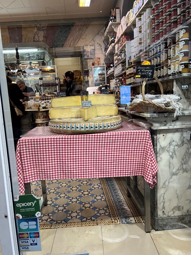 a photo of the inside of a fromagerie (cheese store)